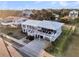 An aerial shot showing the attractive white exterior of a charming beachside house with ample decking at 407 Palmetto Blvd, Edisto Beach, SC 29438