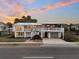 Charming elevated beach home with a metal roof, large porch, and ground-level garage at 407 Palmetto Blvd, Edisto Beach, SC 29438