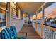 Inviting front porch with seating area, railing, and views of colorful sunset sky in a lovely coastal home at 407 Palmetto Blvd, Edisto Beach, SC 29438
