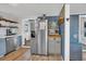 Coastal-themed kitchen featuring stainless steel appliances, light wood floors, and blue accents at 407 Palmetto Blvd, Edisto Beach, SC 29438