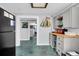 Efficient kitchenette with gray cabinets, butcher block counters and a view to another room at 407 Palmetto Blvd, Edisto Beach, SC 29438