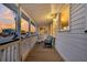 Relax on the porch with the ocean breeze, beautiful sunset views, and comfortable seating at 407 Palmetto Blvd, Edisto Beach, SC 29438