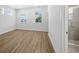 Bright bedroom featuring multiple windows, wood flooring, and an attached bathroom with a glass shower at 4432 Oakwood Ave, North Charleston, SC 29405