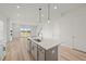Bright kitchen with an island sink and stainless steel dishwasher overlooking the living area at 4432 Oakwood Ave, North Charleston, SC 29405