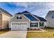 New construction single-Gathering home featuring a two-car garage and manicured front lawn at 478 Rowley Ln, Summerville, SC 29486