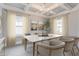 Elegant dining room with a coffered ceiling, large windows, modern chandelier, and marble table at 478 Rowley Ln, Summerville, SC 29486