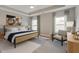 Well-lit main bedroom offers a ceiling fan, neutral paint, stylish furniture, and natural light at 478 Rowley Ln, Summerville, SC 29486