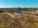 Aerial view of a home and farmland in a rural setting; several buildings are on the property at 516 & 508 Robnshers Pl, Ridgeville, SC 29472