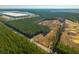 A sprawling property featuring a residence nestled amongst mature trees in a rural setting with commercial buildings nearby at 516 & 508 Robnshers Pl, Ridgeville, SC 29472