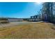 Sprawling property featuring a home and a detached two-car garage, with a large grassy area, and mature trees at 516 & 508 Robnshers Pl, Ridgeville, SC 29472