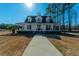 Charming two-story home with a welcoming wraparound porch and well-maintained landscaping on a sunny day at 516 & 508 Robnshers Pl, Ridgeville, SC 29472