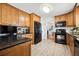 Functional kitchen with wood cabinets, black appliances, and tile backsplash, providing a stylish cooking experience at 516 & 508 Robnshers Pl, Ridgeville, SC 29472