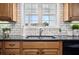 Charming kitchen sink area features subway tile backsplash, a bright window, and modern fixtures for convenience at 516 & 508 Robnshers Pl, Ridgeville, SC 29472