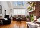Bright living room features a red brick fireplace, hardwood floors, and high ceilings for a spacious feel at 516 & 508 Robnshers Pl, Ridgeville, SC 29472
