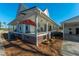 Spacious wraparound porch with classic rocking chairs, decorated with unique decor adding to the charm at 516 & 508 Robnshers Pl, Ridgeville, SC 29472