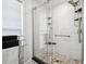 Modern walk-in shower featuring white marbled walls, glass doors, and built-in shelving at 516 & 508 Robnshers Pl, Ridgeville, SC 29472