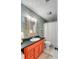 Eclectic bathroom with patterned wallpaper, a unique mirror, and an orange vanity at 521 London Bridge Rd, Mount Pleasant, SC 29464