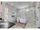 Modern bathroom featuring a soaking tub, glass-enclosed shower, and beautiful tile work at 521 London Bridge Rd, Mount Pleasant, SC 29464
