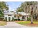 Inviting single-story home boasts a manicured lawn, a classic design, and mature landscaping at 521 London Bridge Rd, Mount Pleasant, SC 29464