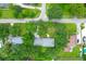 This aerial view highlights a home surrounded by mature trees and well-maintained lawns in a residential neighborhood at 652 E Hobcaw Dr, Mount Pleasant, SC 29464