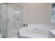 Bright bathroom featuring a shower and large soaking tub at 652 E Hobcaw Dr, Mount Pleasant, SC 29464
