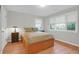 Well-lit bedroom featuring hardwood floors and a queen bed with coordinating nightstands at 652 E Hobcaw Dr, Mount Pleasant, SC 29464