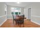 Dining room with a wooden table, chairs, hardwood floors, and ample natural light at 652 E Hobcaw Dr, Mount Pleasant, SC 29464