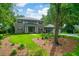This is a stately two-story home featuring a brick facade, mature trees, a manicured lawn, and a welcoming front entrance at 652 E Hobcaw Dr, Mount Pleasant, SC 29464