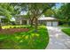 Beautiful two-story brick home with lush landscaping and a well-manicured lawn at 652 E Hobcaw Dr, Mount Pleasant, SC 29464