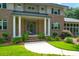 This is a welcoming home entrance featuring brick accents, columns, and a well-manicured lawn and mature landscaping at 652 E Hobcaw Dr, Mount Pleasant, SC 29464