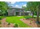 Beautiful two-story brick home with a meticulously manicured lawn, mature trees and professional landscaping at 652 E Hobcaw Dr, Mount Pleasant, SC 29464