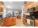 Open kitchen with stainless appliances, a large island with granite countertops, and hardwood cabinets at 652 E Hobcaw Dr, Mount Pleasant, SC 29464