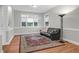 Bright and airy living room with hardwood floors, large windows, and a comfortable leather sofa at 652 E Hobcaw Dr, Mount Pleasant, SC 29464