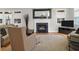 Bright living room with a fireplace, large windows, hardwood floors, and comfortable seating at 652 E Hobcaw Dr, Mount Pleasant, SC 29464