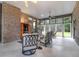 Relaxing sunroom with brick walls, ceiling fans, and a panoramic view of the surrounding landscape at 652 E Hobcaw Dr, Mount Pleasant, SC 29464