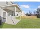 Large backyard with a covered patio, privacy fence, and green grass at 7806 Park Gate Dr, North Charleston, SC 29418