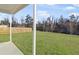 A covered patio looks out on to a wide green lawn, offering privacy fencing at 7806 Park Gate Dr, North Charleston, SC 29418