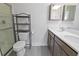 Modern bathroom features double sinks, a shower, and stylish shelving unit at 7806 Park Gate Dr, North Charleston, SC 29418