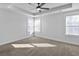 A spacious bedroom has light carpet, two windows, and a ceiling fan at 7806 Park Gate Dr, North Charleston, SC 29418