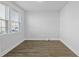 Bright bedroom with wood-look floors, neutral walls, and natural light from large window at 7806 Park Gate Dr, North Charleston, SC 29418