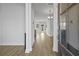 Inviting entryway with light wood flooring, white walls, and view to chandelier and rear windows at 7806 Park Gate Dr, North Charleston, SC 29418