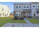 Charming townhome featuring stone accents, light gray siding, and a well-manicured front lawn at 7806 Park Gate Dr, North Charleston, SC 29418