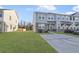 Attractive townhome showcasing light gray siding, stone accents, and a spacious front lawn at 7806 Park Gate Dr, North Charleston, SC 29418