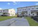 Beautiful townhome featuring stone accents, light gray siding, and a spacious concrete driveway at 7806 Park Gate Dr, North Charleston, SC 29418