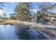 Scenic playground and pond area surrounded by trees and open space in a residential community at 7806 Park Gate Dr, North Charleston, SC 29418