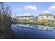 A scenic pond reflects the surrounding houses and blue skies at 7806 Park Gate Dr, North Charleston, SC 29418