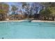 Large community swimming pool with lane markers and clear water, surrounded by trees and seating areas at 7806 Park Gate Dr, North Charleston, SC 29418