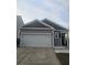 Charming one-story home with a large garage, gray siding, and well-manicured lawn at 9715 Brandishing Rd, Ladson, SC 29456
