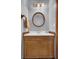 Bathroom features a wooden vanity with a solid white countertop and a framed circular mirror at 102 Eastover Cir, Summerville, SC 29483
