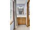 Bathroom with wood vanity, framed mirror, and window, showcasing functionality and natural light at 102 Eastover Cir, Summerville, SC 29483